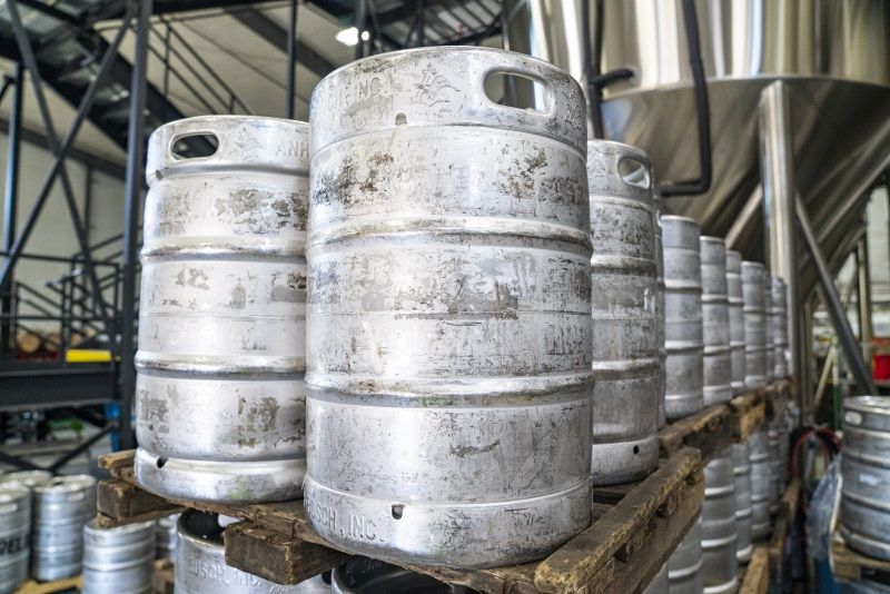 Four silver kegs inside brewery
