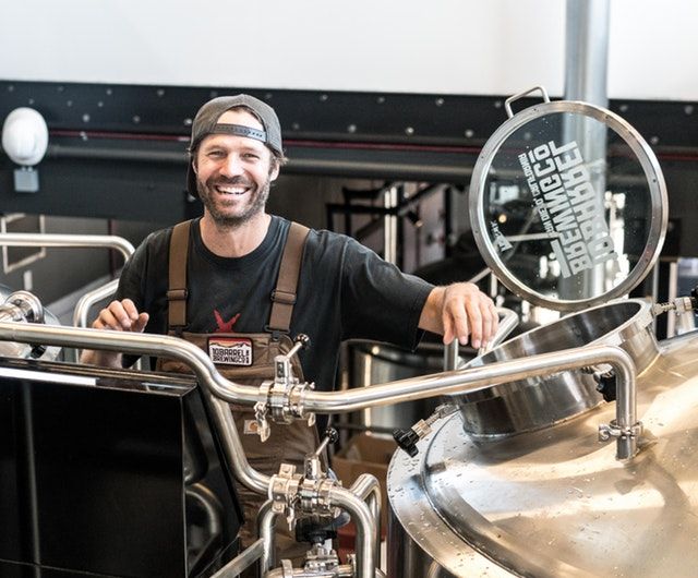 Man smiling while working at brewery